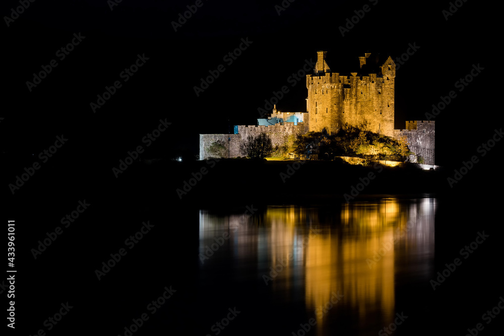 Eilean Donan Castle during a night with nice reflection in water. Long exposure. Dornie in Scotland