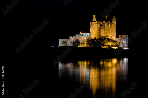 Eilean Donan Castle during a night with nice reflection in water. Long exposure. Dornie in Scotland photo