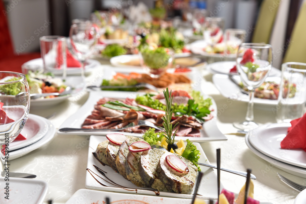 Banquet table with delicious food in a restaurant. Professional and exquisite dish serving at restaurant. Catering service