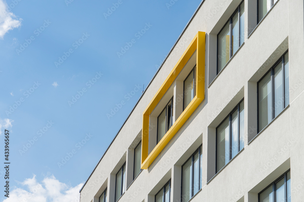 Fragment of modern building facade exterior with blue sky background