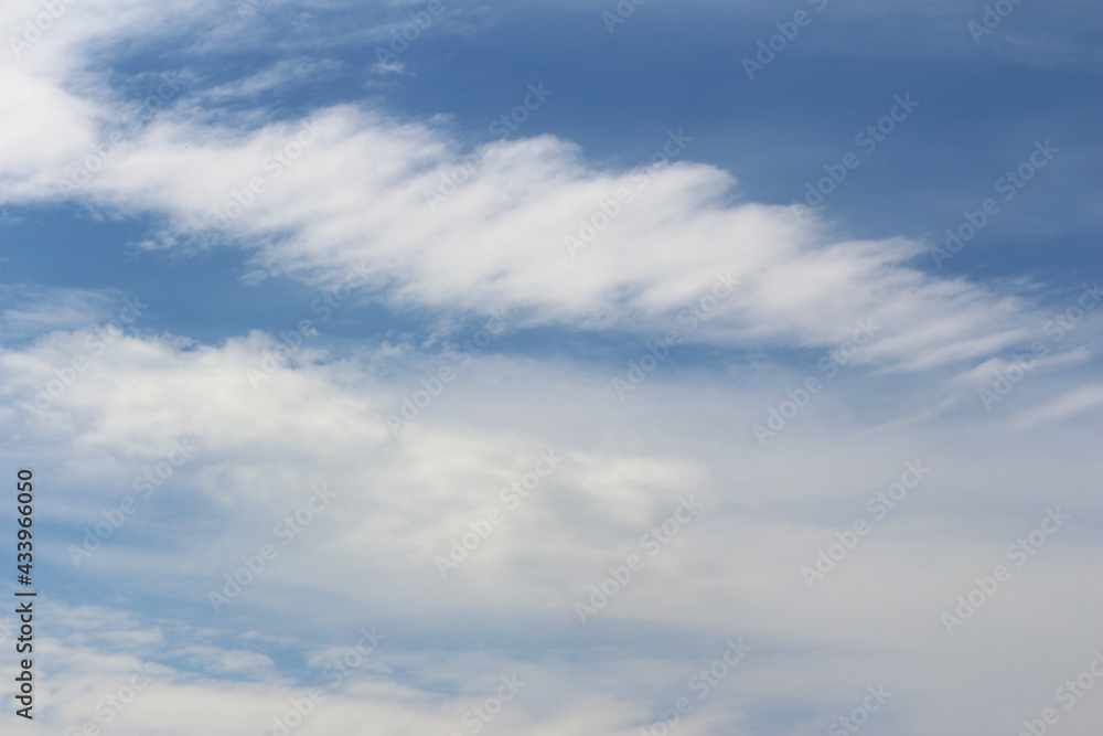 Clouds on bright blue sky background