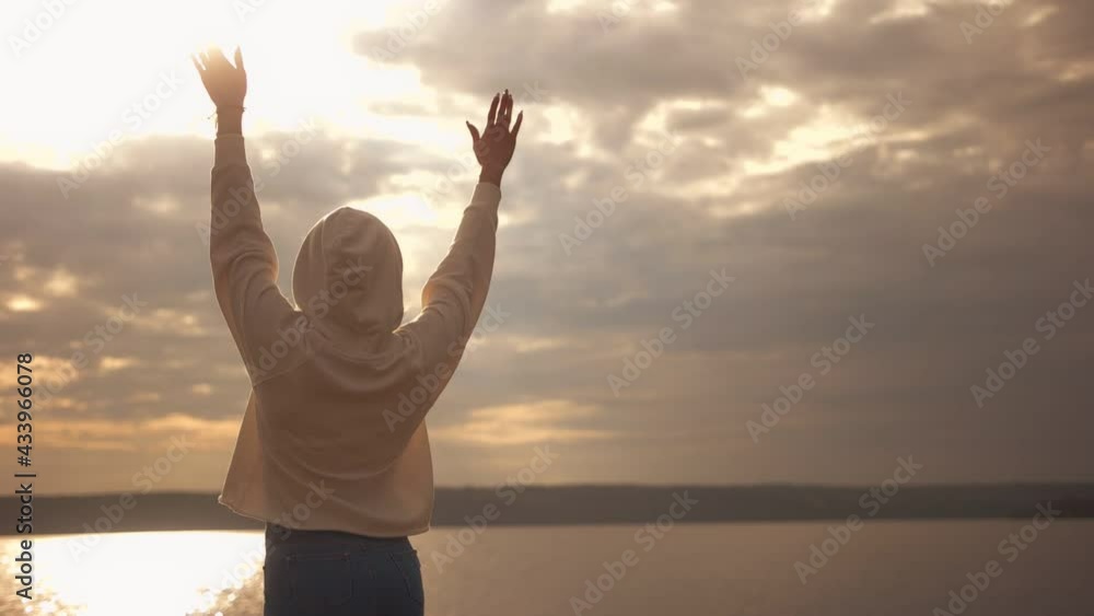 A slender girl admires the sunset. Slow motion. A slender girl admires the sunset. Slow motion.