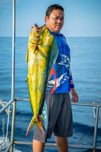 Lucky fisherman holding a beautiful dolphin fish