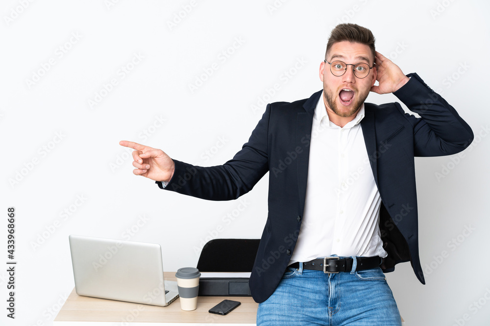Russian man in a office isolated on white background surprised and pointing finger to the side Russian man in a office isolated on white background surprised and pointing finger to the side