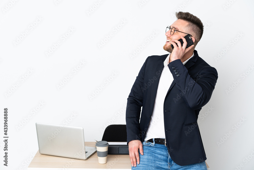 Russian man in a office isolated on white background keeping a conversation with the mobile phone Russian man in a office isolated on white background keeping a conversation with the mobile phone