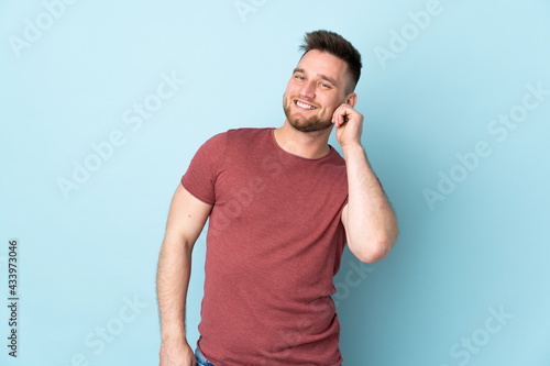 Russian handsome man over isolated background laughing