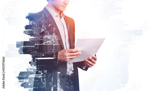 Attractive businesswoman in formal wear holding papers checking photo