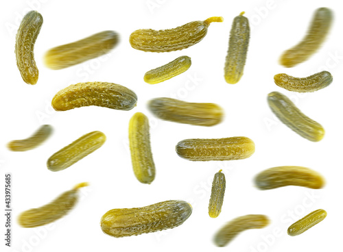 Falling cucumbers. Marinated pickled cucumbers isolated on a white background, selective focus.