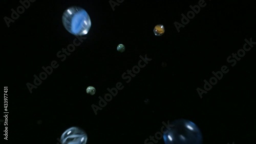 Wallpaper Mural Marbles spheres fall into frame against black background in slow motion   Torontodigital.ca