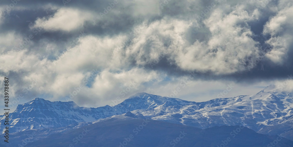 View of the snowy Sierra Nevada a cloudy day; Mulhacén is the highest peak in the Iberian Peninsula