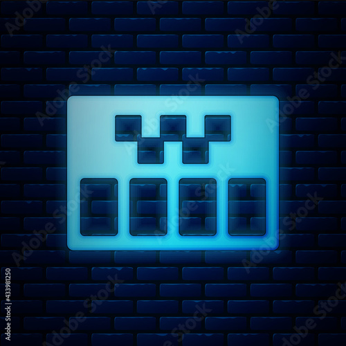 Glowing neon Taximeter device icon isolated on brick wall background. Measurement appliance for passenger fare in taxi car. Vector