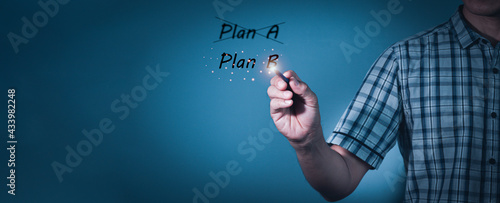Business plan strategy changing.The man crossing over Plan A, writing Plan B.Concept is . Improvement, modernization. Flexibility and business adaptation to new conditions. Rethinking old approaches. photo