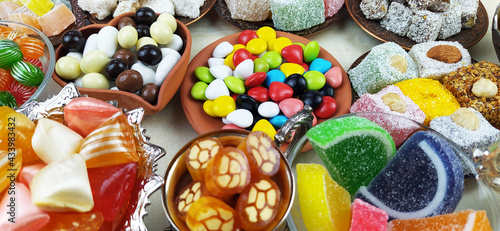 All kinds of candies and marshmallows on various plates on white background.Traditional Turkish Delight, Turkish Sweet Sugar Ramadan (Ramadan) Food