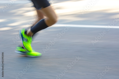 Photography blurry and unsharp legs of a running athlete at a marathon distance