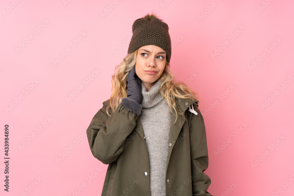 Young girl with winter hat isolated on pink background thinking an idea Young girl with winter hat isolated on pink background thinking an idea