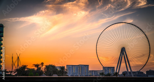Sunset on Bluewaters Island, with the famous Ain Dubai Ferris wheel, with shot point from Marina Beach Perfect shot for travel, vacations and vacations.