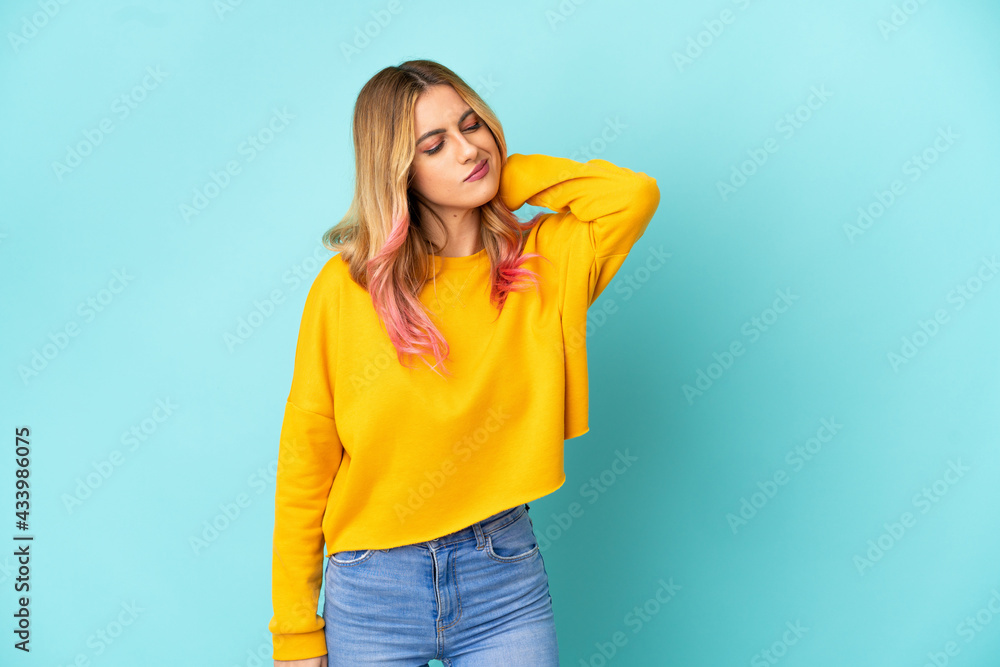 Young woman over isolated blue background with neckache Young woman over isolated blue background with neckache