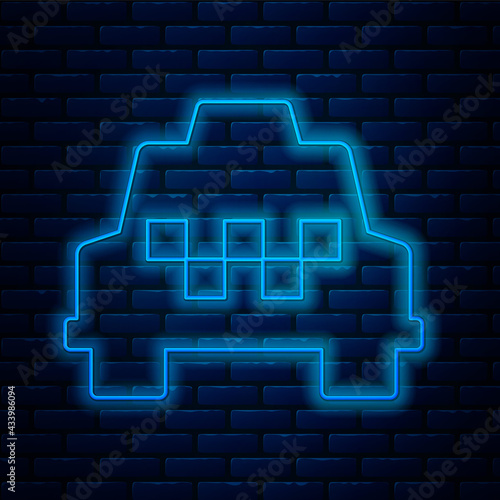 Glowing neon line Taxi car icon isolated on brick wall background. Vector