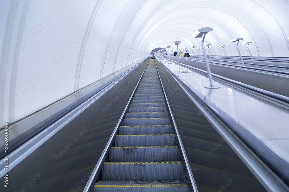 Escalator in the metro. Lifting ladder.The movement of passengers in the subway. Escalator in the metro. Lifting ladder.The movement of passengers in the subway.