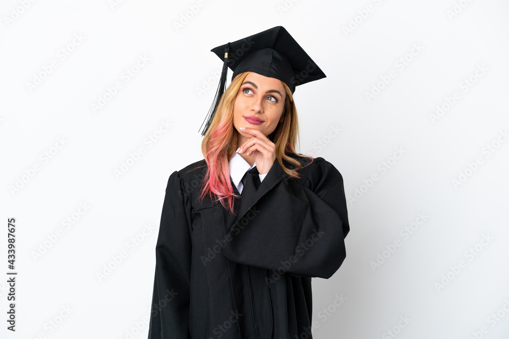 Young university graduate over isolated white background and looking up Young university graduate over isolated white background and looking up