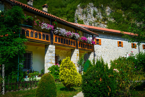 Monastery building with flowers in the background of mountains in Montenegro.