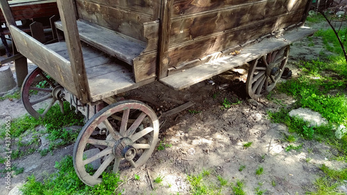 old stagecoach, with carriage wheels on a grassy ground