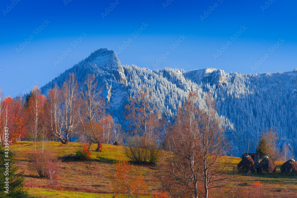 Fototapeta premium Mountain lanscape in november. Late autumn scene with snow on Ceahlau mountain, Romania