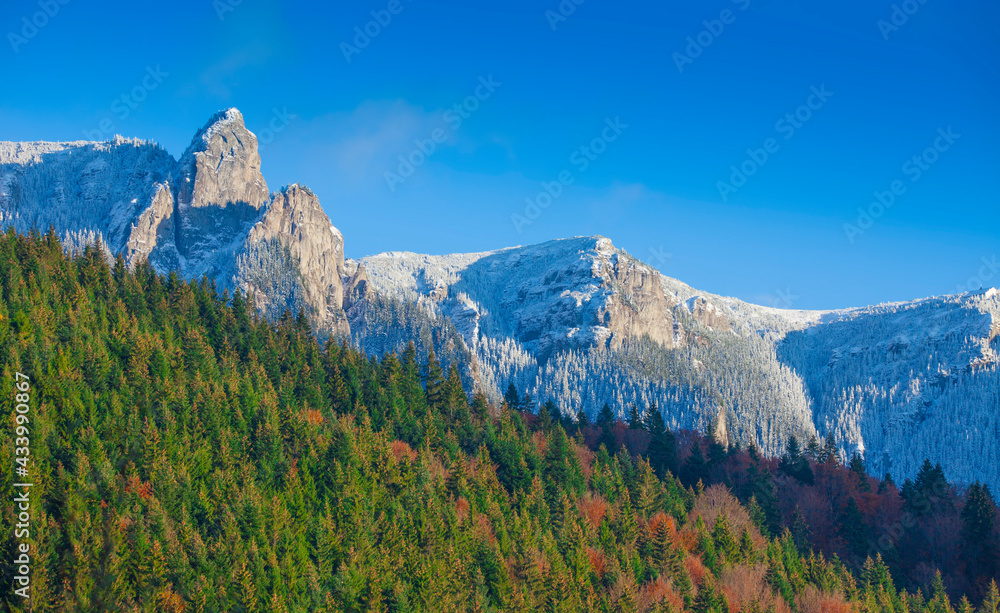 beautiful mountainl landscape in Ceahlau, Romania. forest and rock scene with snow