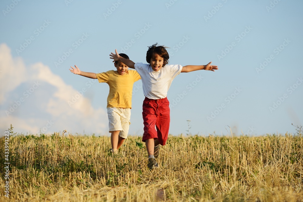 Happy children running on beautiful field Happy children running on beautiful field
