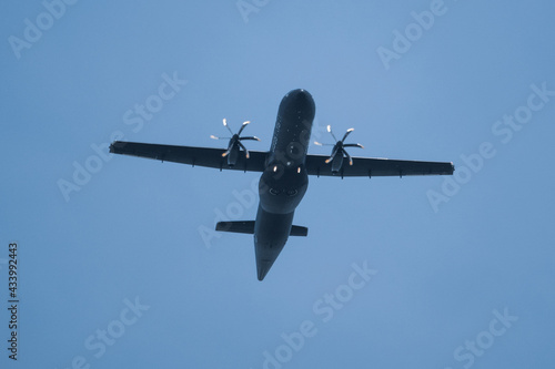 dark propeller plane flies very low