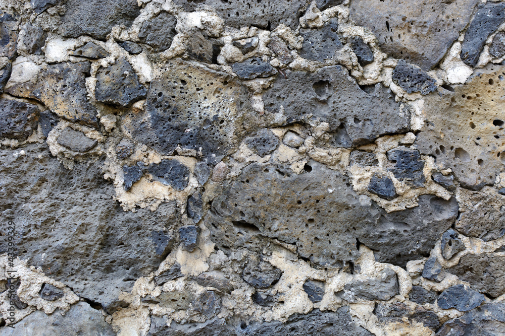 Texture of wall made of stone. Stone wall from colonial times.