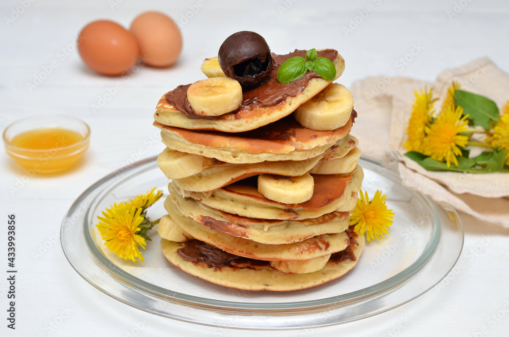 pancakes with chocolate and banana and dandelion flowers pancakes with chocolate and banana and dandelion flowers