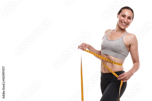 sporty slim woman with measuring tape