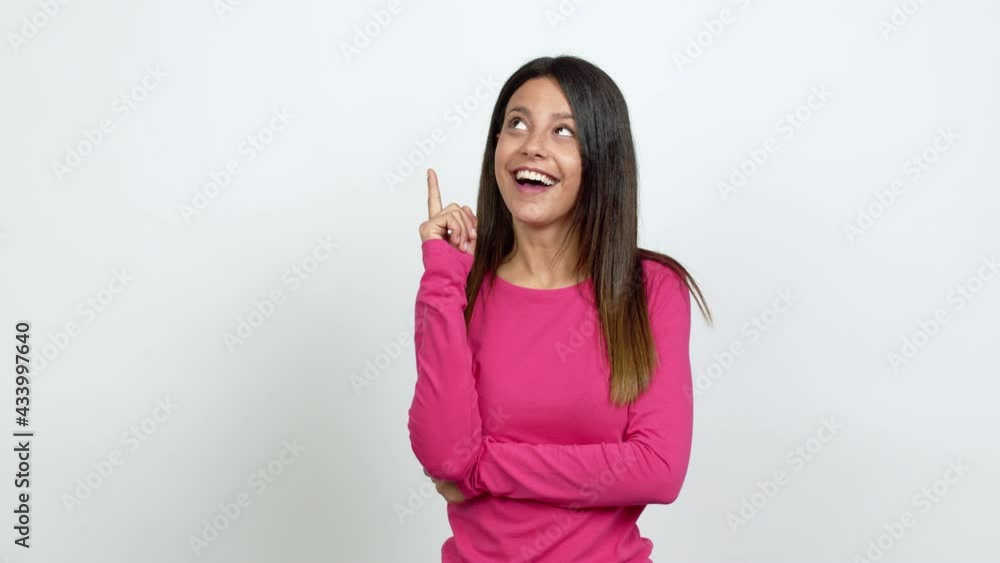 Young woman standing and thinking an idea pointing the finger up over isolated background Young woman standing and thinking an idea pointing the finger up over isolated background