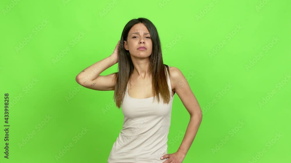 Young woman having doubts while scratching head over isolated background Young woman having doubts while scratching head over isolated background