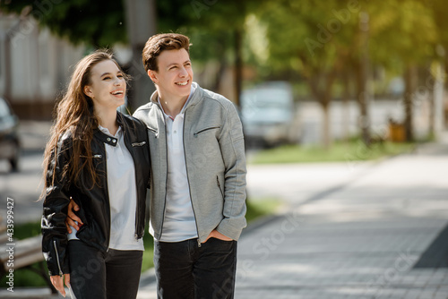 young happy beautiful couple laughing and hugging in the street.   . © Med Photo Studio