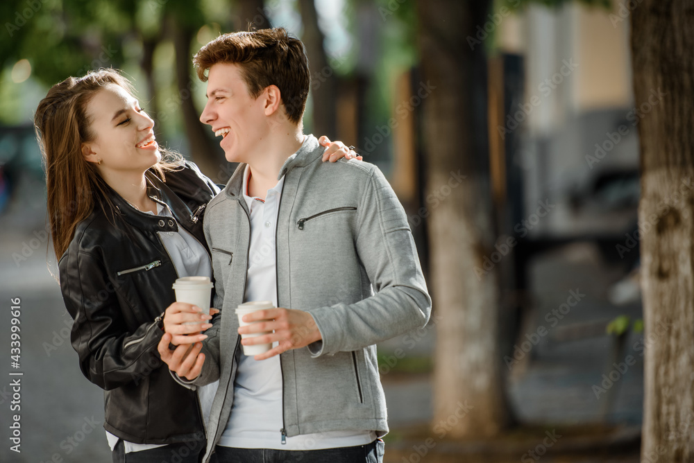 Young happy beautiful couple walking in the street. Young happy beautiful couple walking in the street.