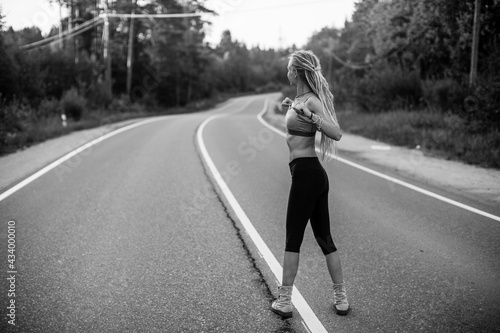 Running woman warm-up before jogging. Black and white photo.