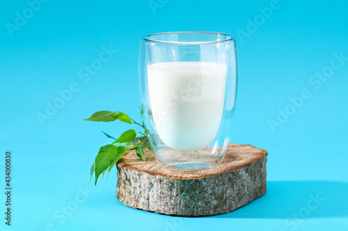 Glass of milk on a blue background. Milk products.