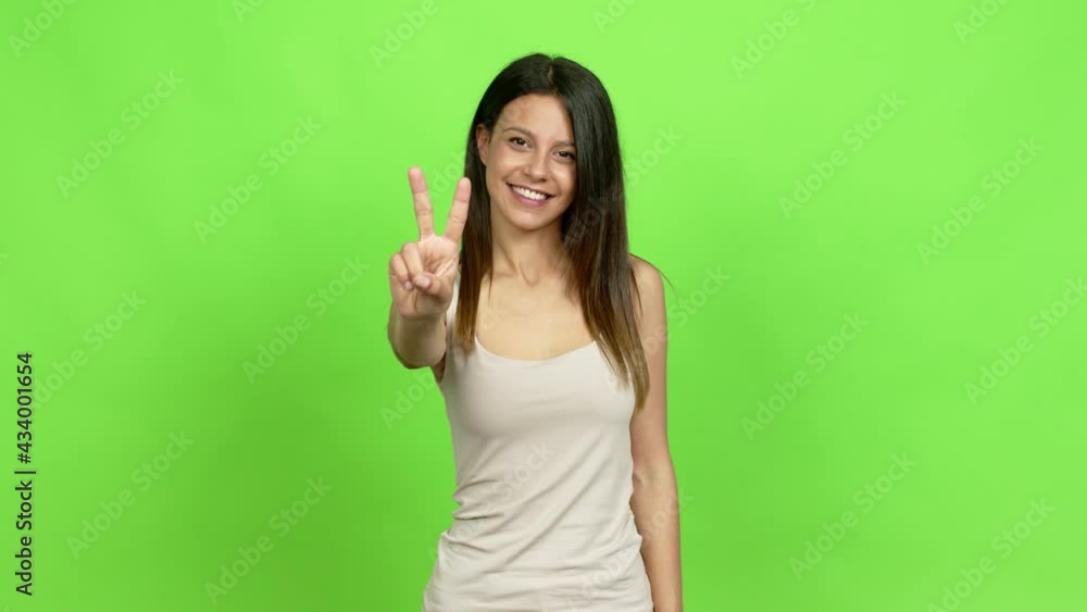 Young woman happy and counting with fingers over isolated background Young woman happy and counting with fingers over isolated background