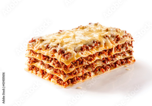 slice of lasagna with melted cheese on top and minced meat filling close-up isolated on white background with shadow