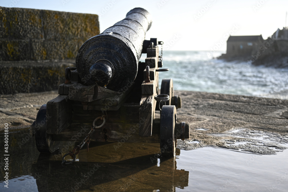 cannon pointing out to sea, war icon or background photo
