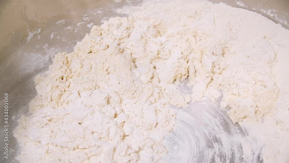 Container of big bakery mixer and mixer blades are cleaned of of dough residues Container of big bakery mixer and mixer blades are cleaned of of dough residues