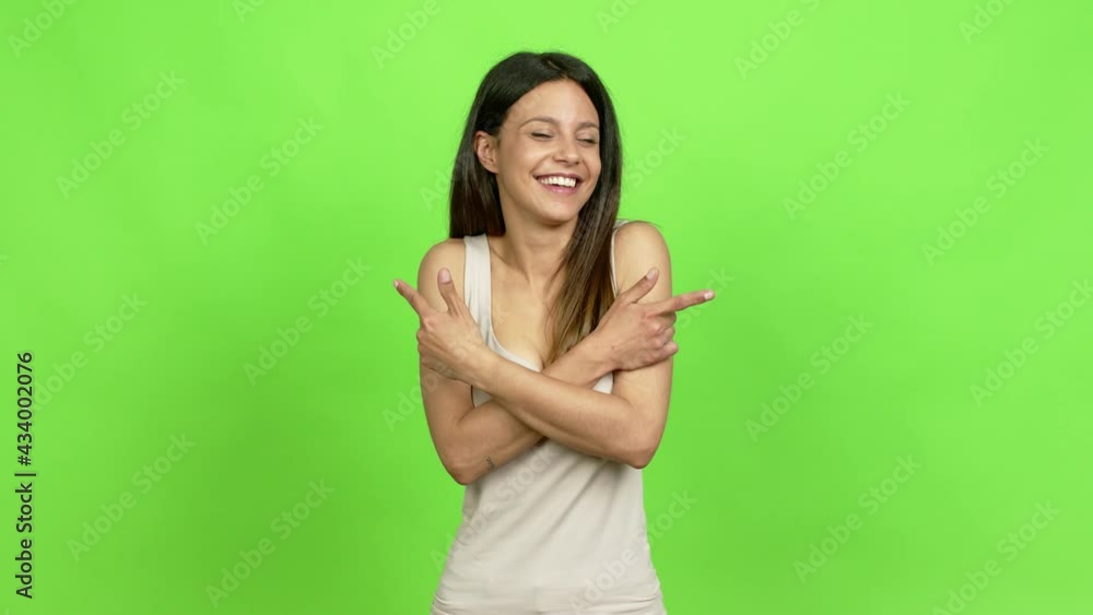 Young woman pointing to the laterals having doubts over isolated background Young woman pointing to the laterals having doubts over isolated background