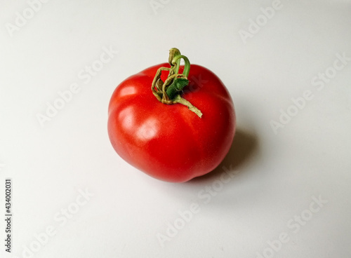 red tomatoes on a wooden background