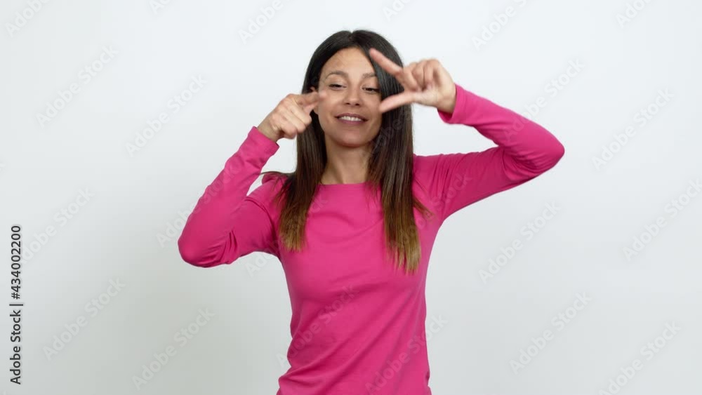 Young woman focusing with fingers over isolated background Young woman focusing with fingers over isolated background