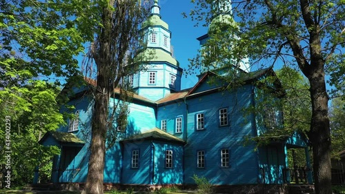 Aerial View of wooden church surrounded by high old trees. Pereyaslav-Khmelnitsky Museum of Folk Architecture and Life of the Middle Naddnipryanshchyna. photo