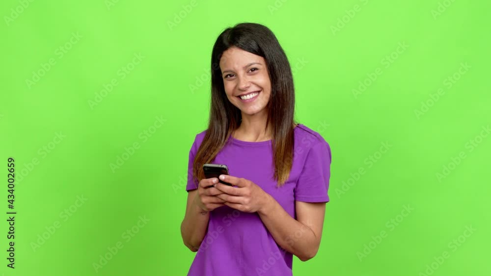 Young woman using mobile phone over isolated background Young woman using mobile phone over isolated background
