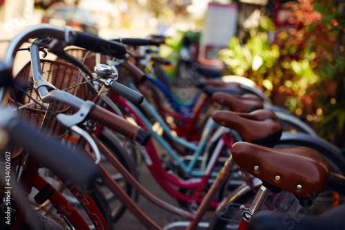 Canvas Print Parked retro bicycle with wicker baskets for tourist rent