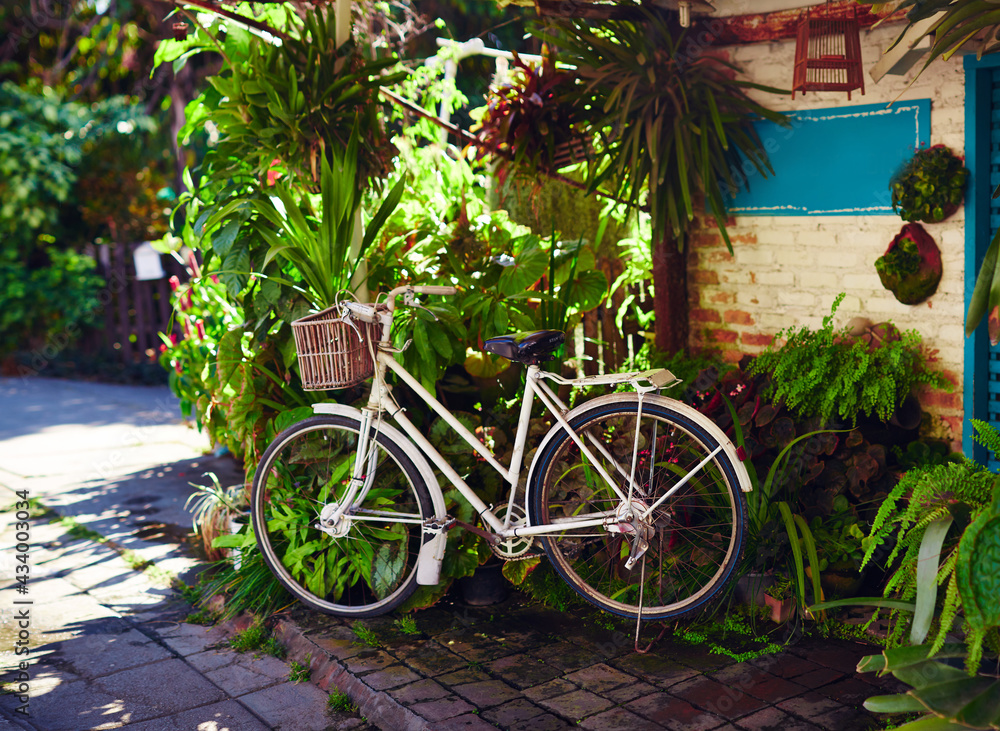 Parked retro bicycle with wicker baskets for tourist rent. Eco-friendly transport for the city.